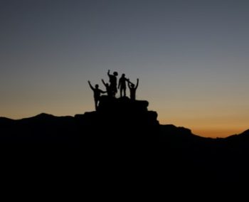 people together on top of mountain