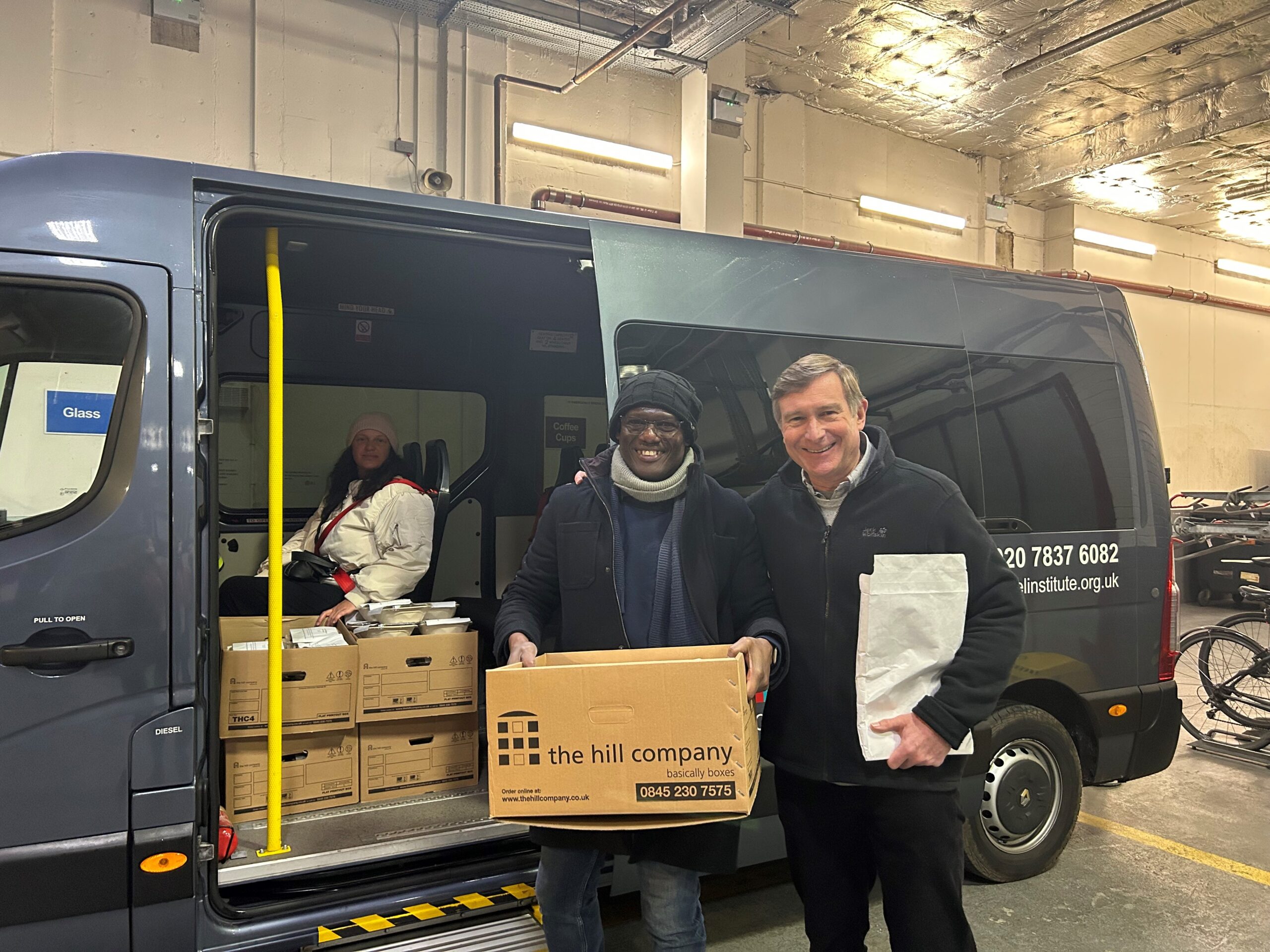 Olu Alake, CEO of The Peel Institute and John Handford of Sarasin & Partners on their way to deliver the hot meals